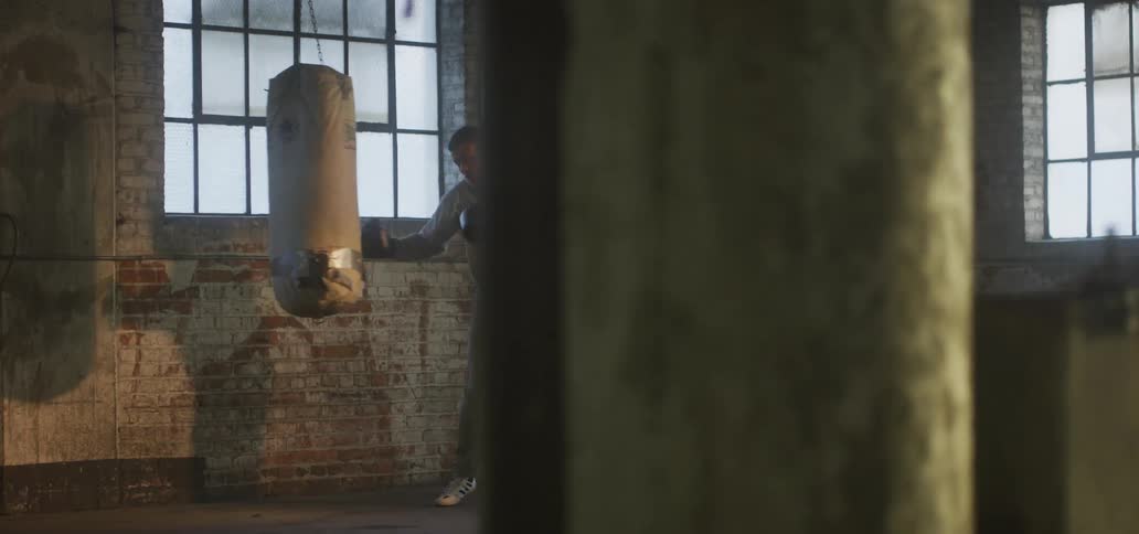A man throws punches at a punching bag