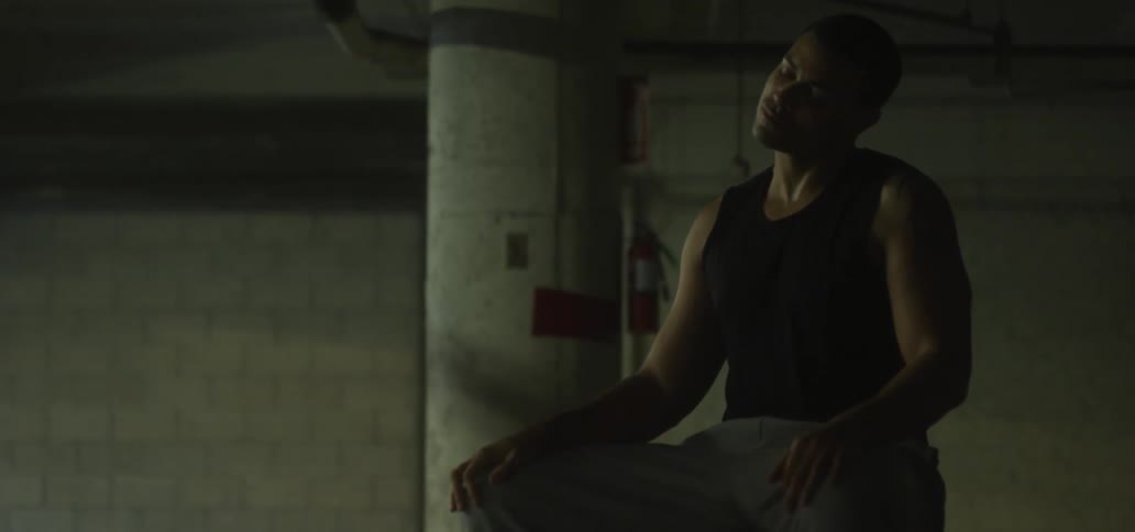 A man sitting and stretching his neck