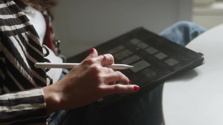A woman scrolling on a tablet