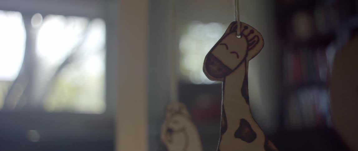 An mobile for an infant includes a dangling giraffe and bird