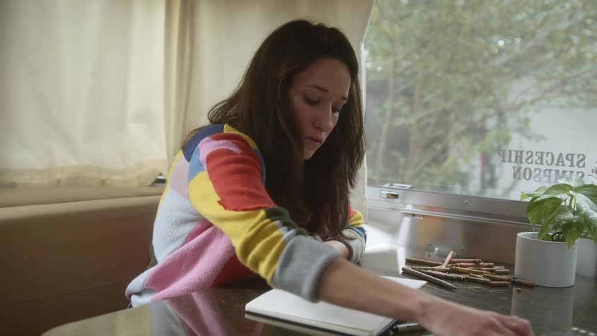A woman drawing in a book