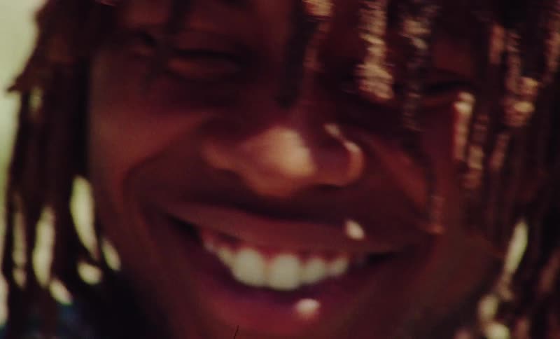 Closeup of man smiling and putting his hands on his head
