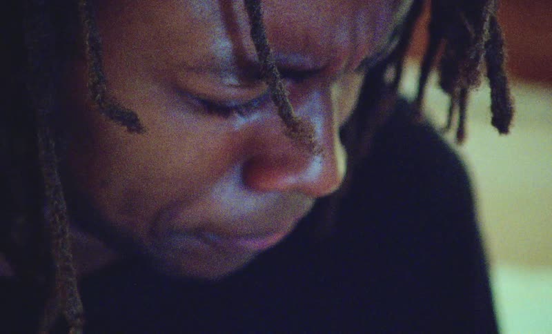 A young male grimaces as he breathes heavily while fighting back tears