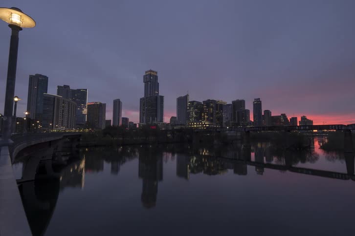 Sun rising over the citys downtown skyline reflecting on the river
