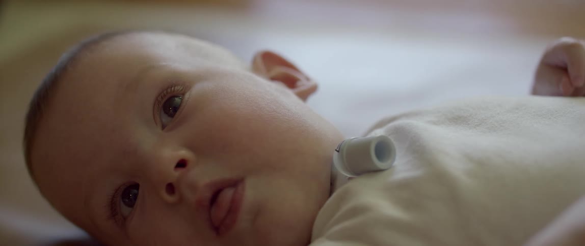 A baby is laying down in the bed