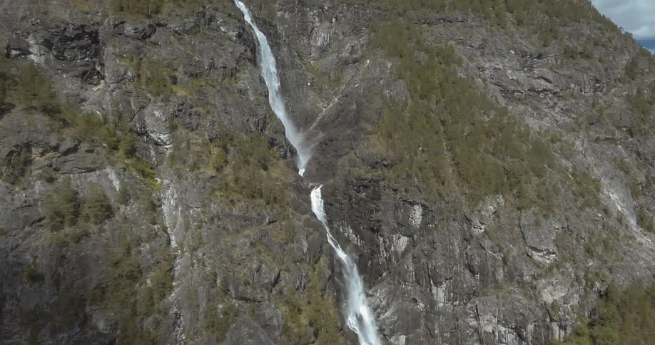 Aerial view of a waterfall on the side of a mountain