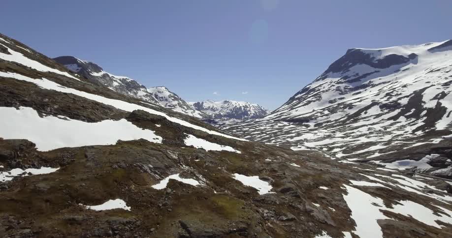 A mountain range with snow under a clear blue sky
