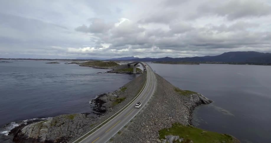 Cars traveling on a highway surrounded by water on both sides