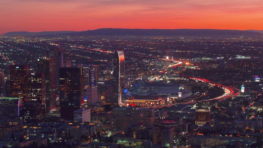 Aerial view of downtown Los Angeles near Crypto.com arena under the red sky at sunset