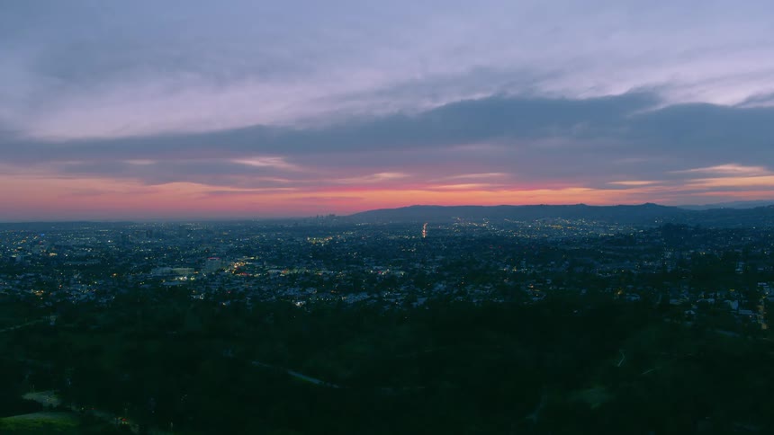 The sky is red above the city at sunset