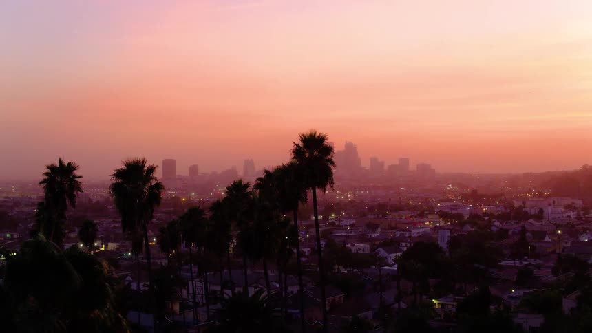 The sky is red as the sun sets over the city