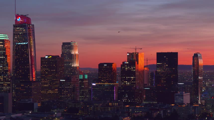The sky is red as the sun sets on the city