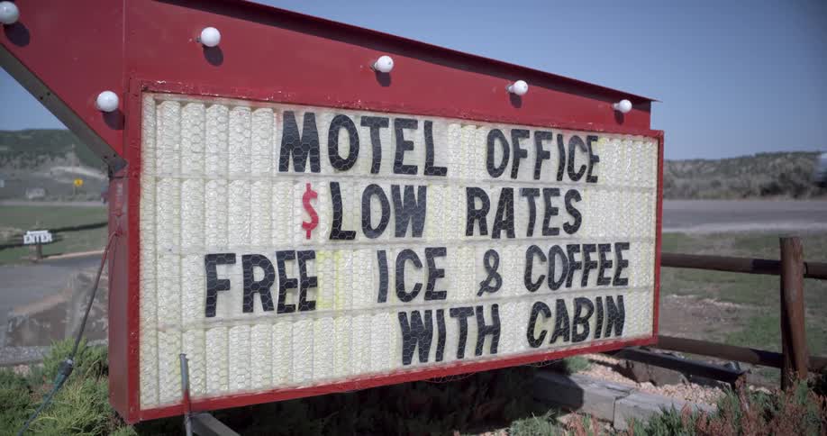 Motel sign at the side of the road in a rural area at day time