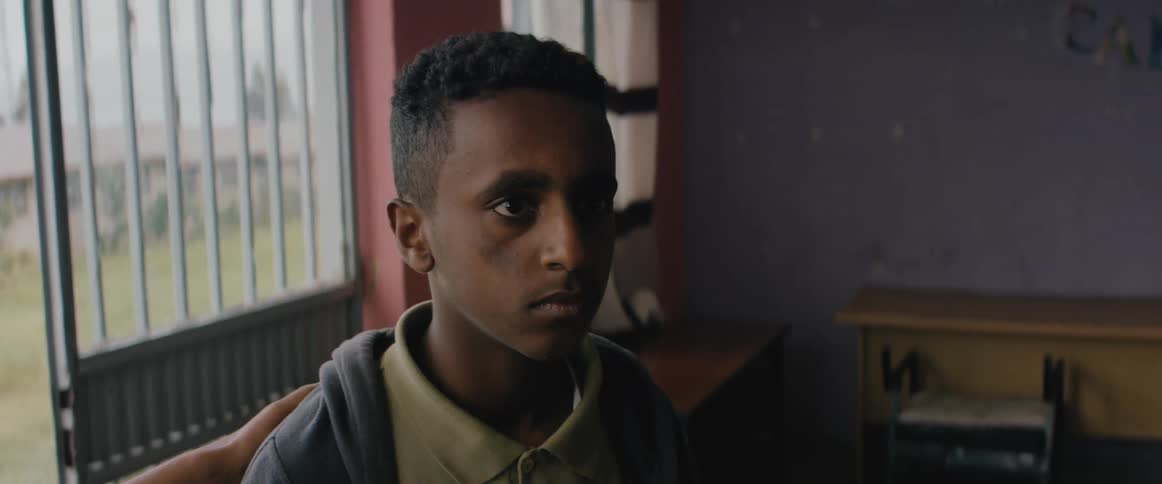 Young scared preoccupied man entering the room of a house
