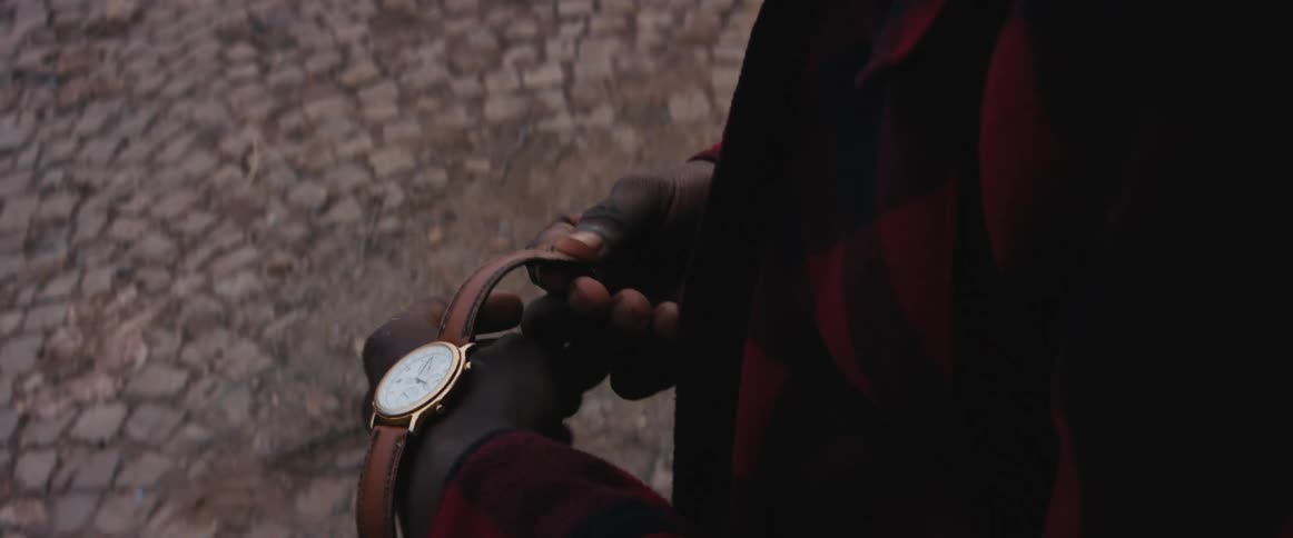 A person removing their watch
