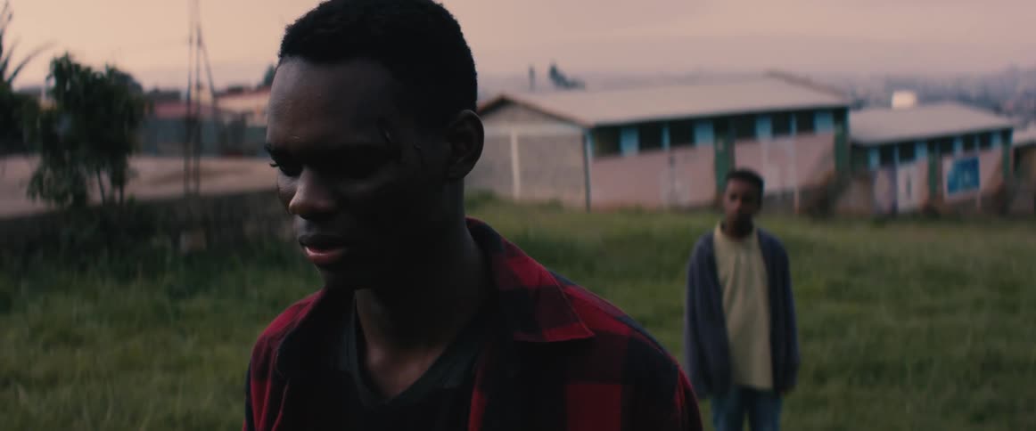 A man is talking with someone behind him
