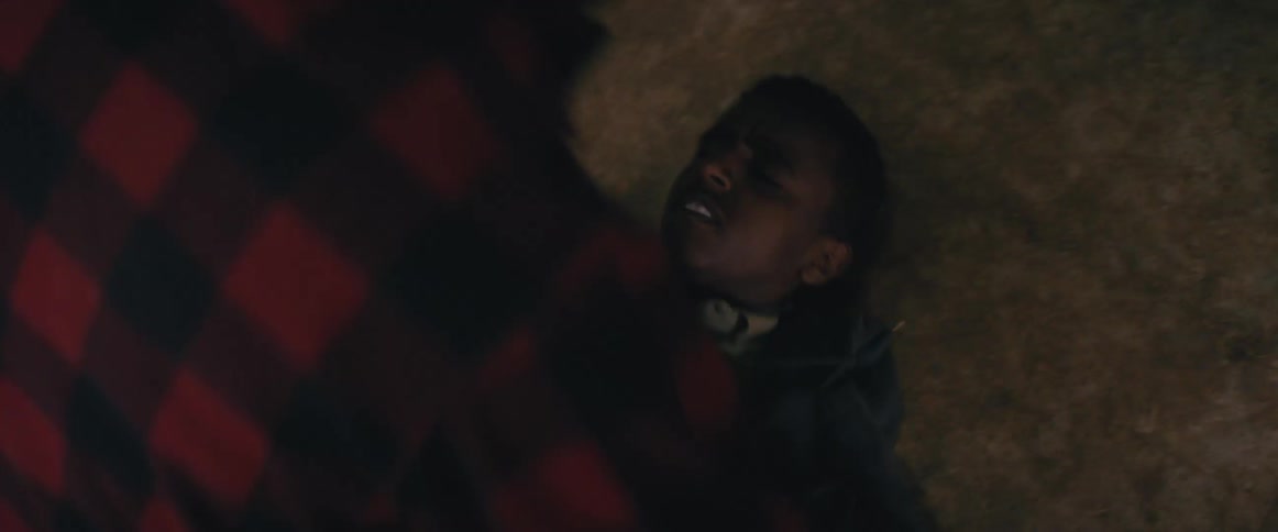 Two boys fight on the ground indoors