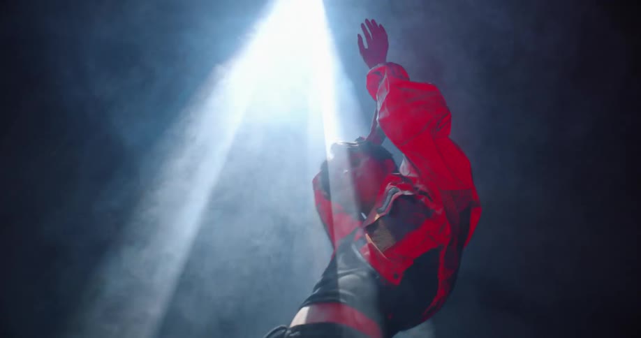 A man standing under a spotlight