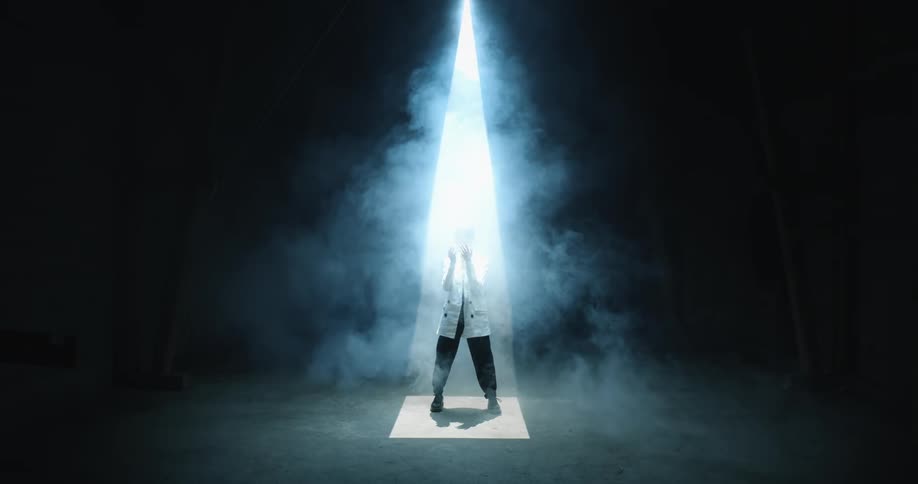 The curtain opens to someone dancing in smoke