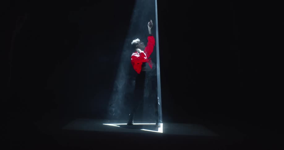 A woman dancing under a spotlight
