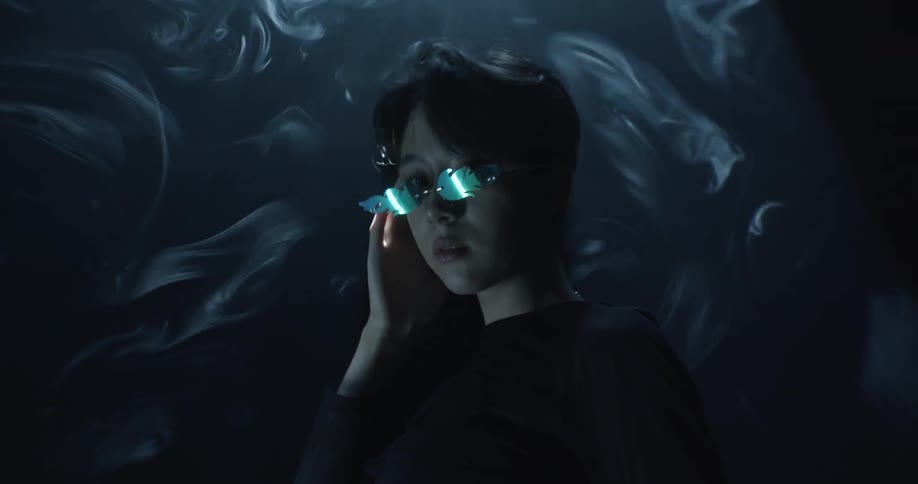 A man with sunglasses in a dark room