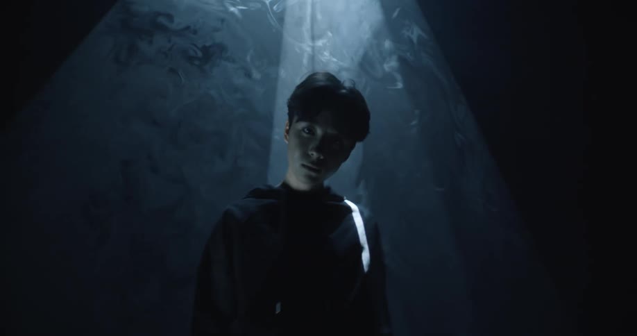 A close up of a man standing under a spotlight
