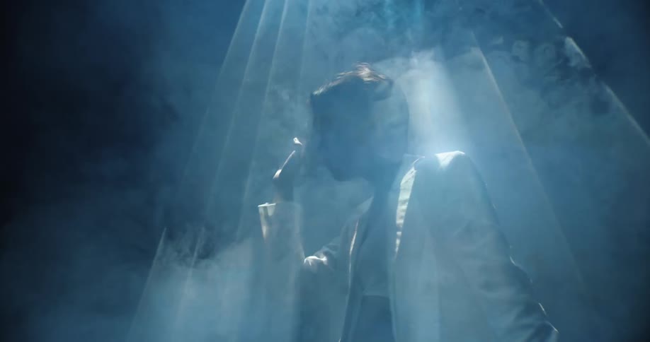 Woman moving in a strobing light and smoke filled environment