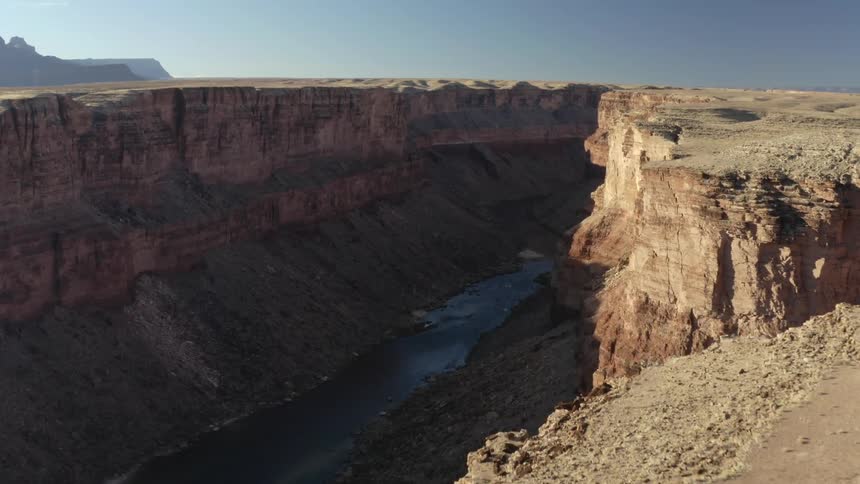 River canyon escarpment and river valley and mountains on the horizon on a clear day