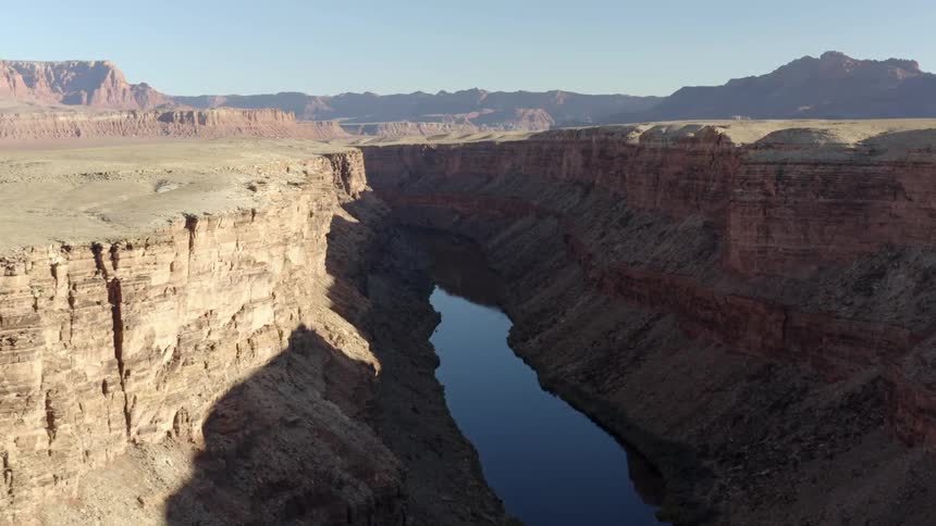 Aerial view of a river running at the bottom of a canyon in the badlands