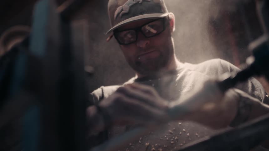 A man works with tools and machinery
