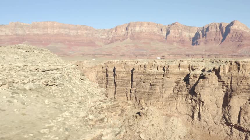 Canyon with mountain range mesa and a clear blue sky