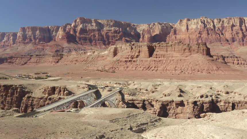 Bridge over canyon and mountain buttes and mesa on a clear day