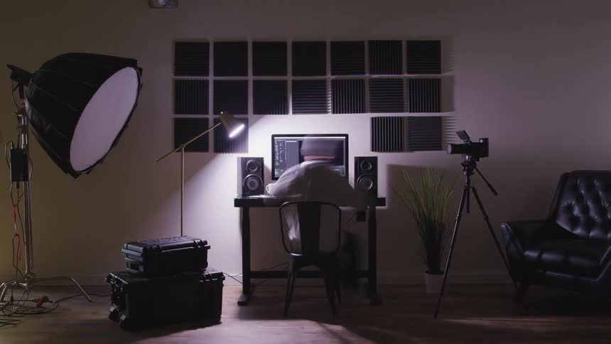 Time lapse of man sitting at a desk watching computer monitor wearing headphones