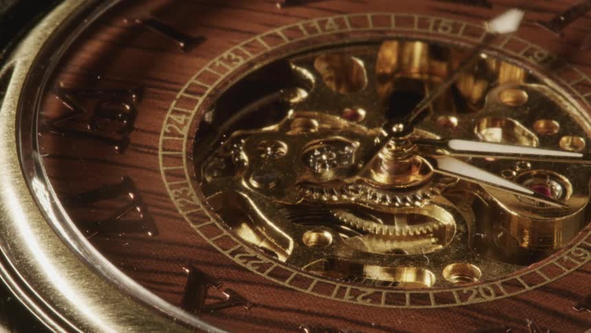 Closeup of a second hand spinning on face of clock