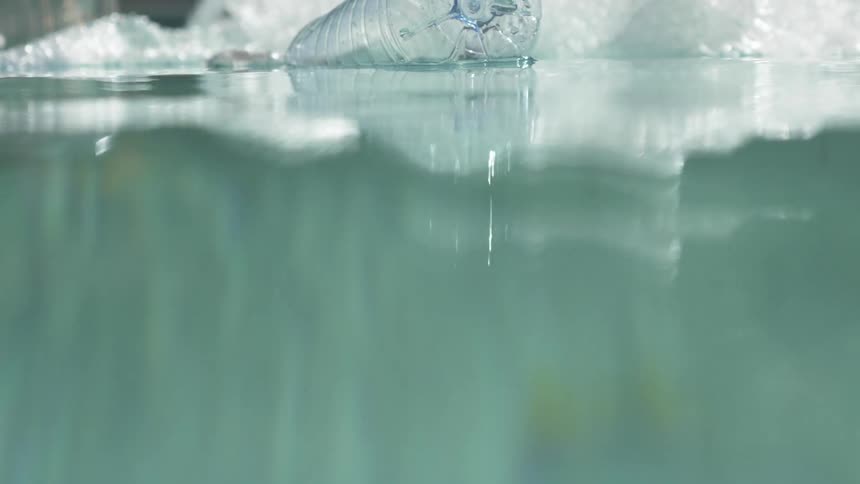 Plastic bottles and bags garbage floating on the surface of water