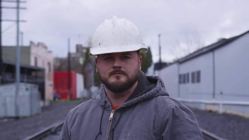 A man standing in front of train tacks