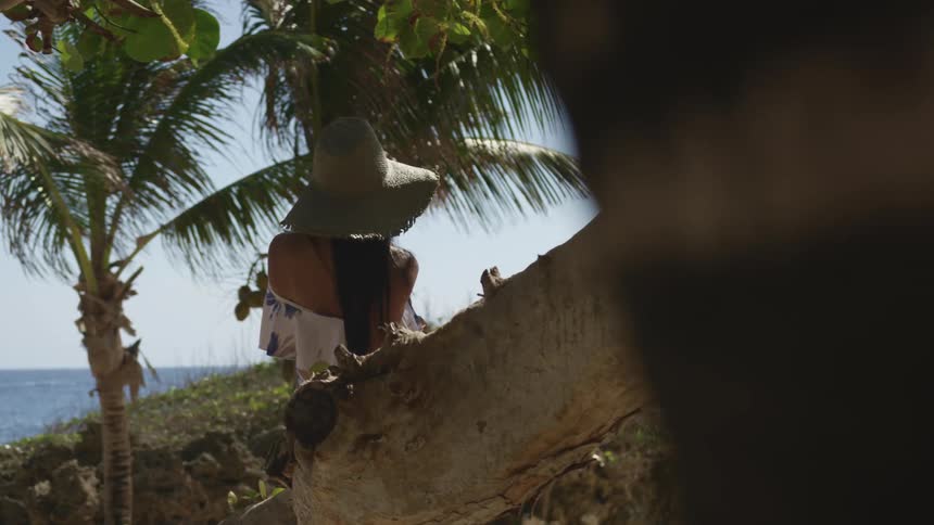 A woman sitting on a costal hill