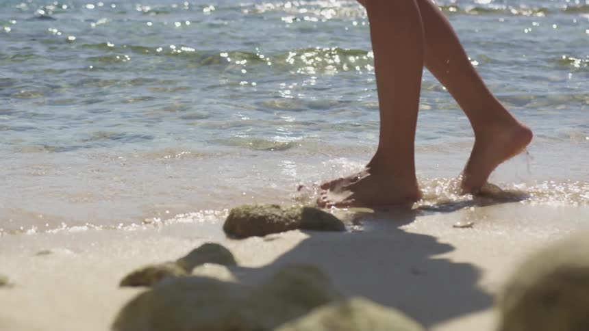 A woman walking on a beach