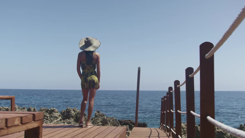 A woman standing on the edge of a pier