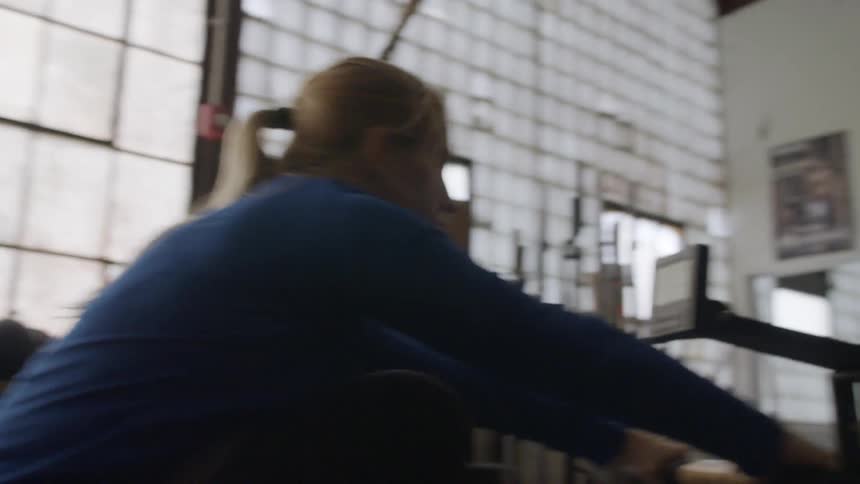Woman using a rowing machine in a gym