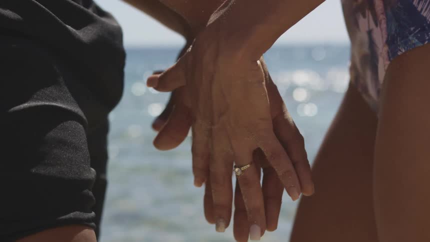 A man and woman locking hands together