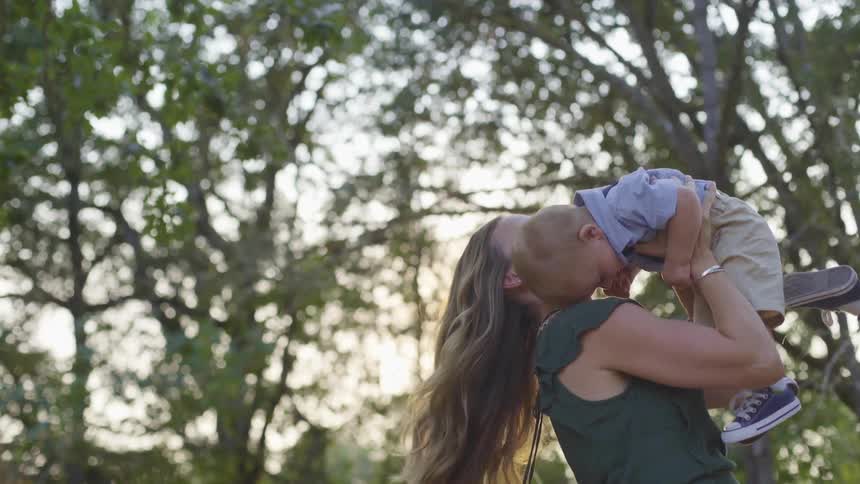 A mother holding her child in the air