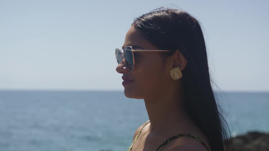 A woman standing in front of an ocean