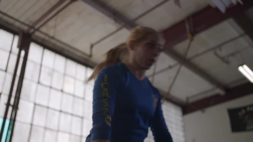 A woman is lifting free weights