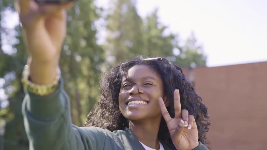 A woman taking a selfie on a phone