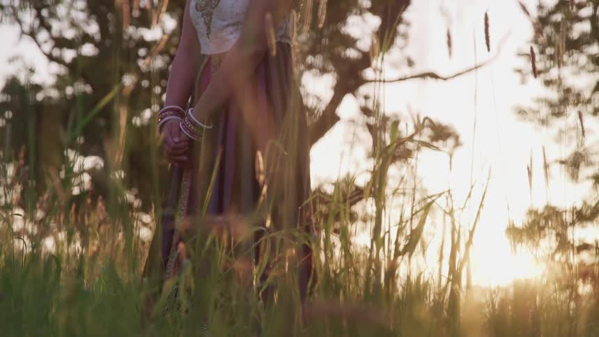 A woman standing in tall grass