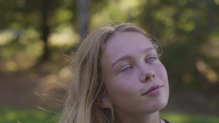 A girl looks up on a windy day