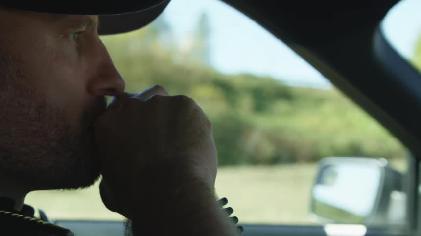 A man is driving a vehicle and spoke on a radio