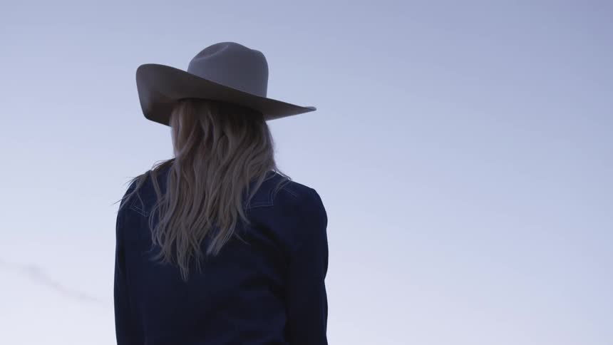 A woman looks around outside