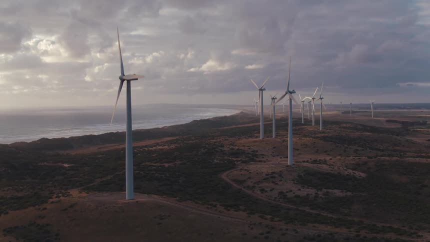 Wind turbines on rural land on a cloudy day